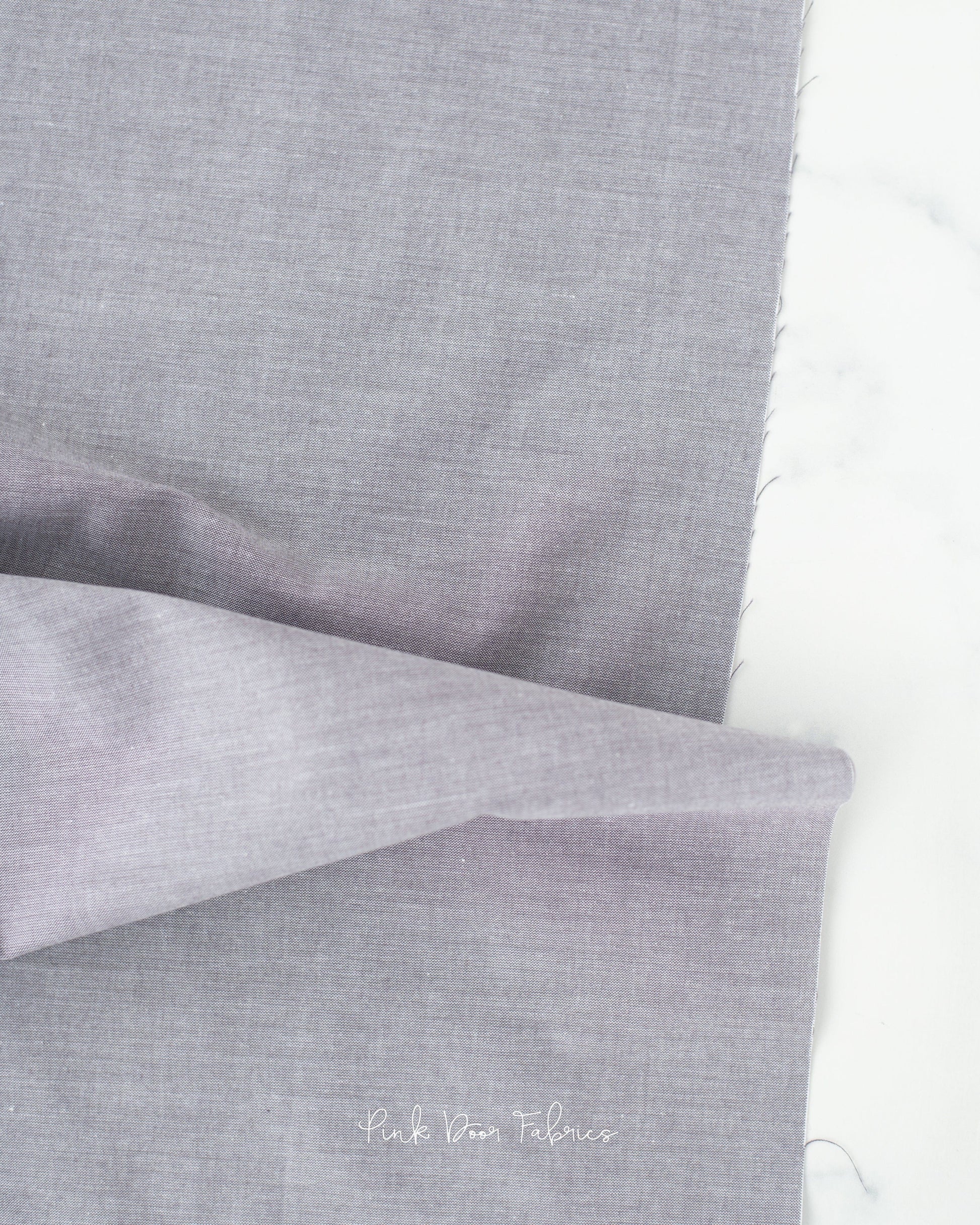 Chambray quilting fabric pattern called 'Grey'. Part of the 'Chambray Solids' fabric collection. Designed by Tilda Fabrics for the Tilda Fabrics fabric company. SKU: 160006. 44-45 inch width.