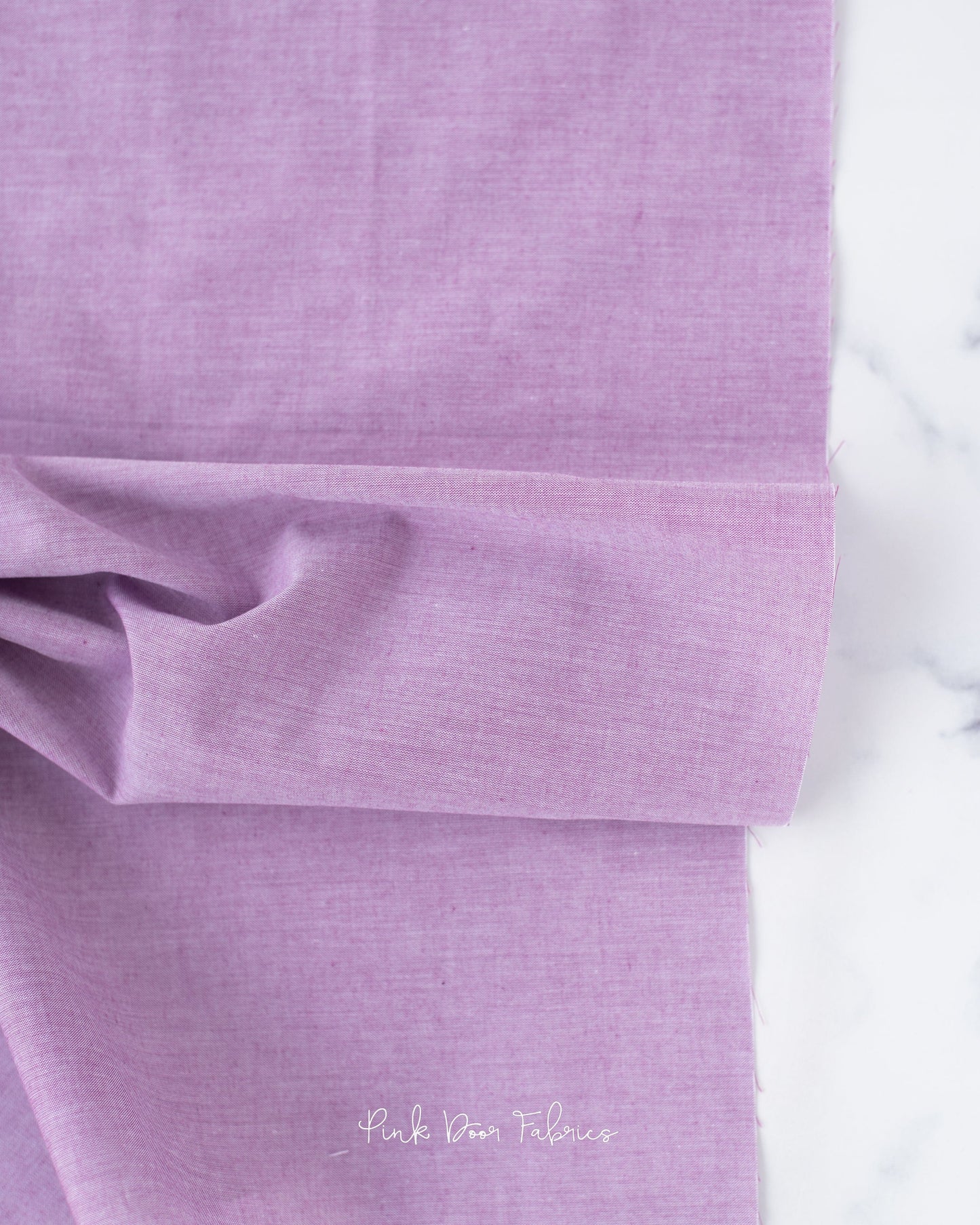 Chambray quilting fabric pattern called 'Plum'. Part of the 'Chambray Solids' fabric collection. Designed by Tilda Fabrics for the Tilda Fabrics fabric company. SKU: 160010. 44-45 inch width.