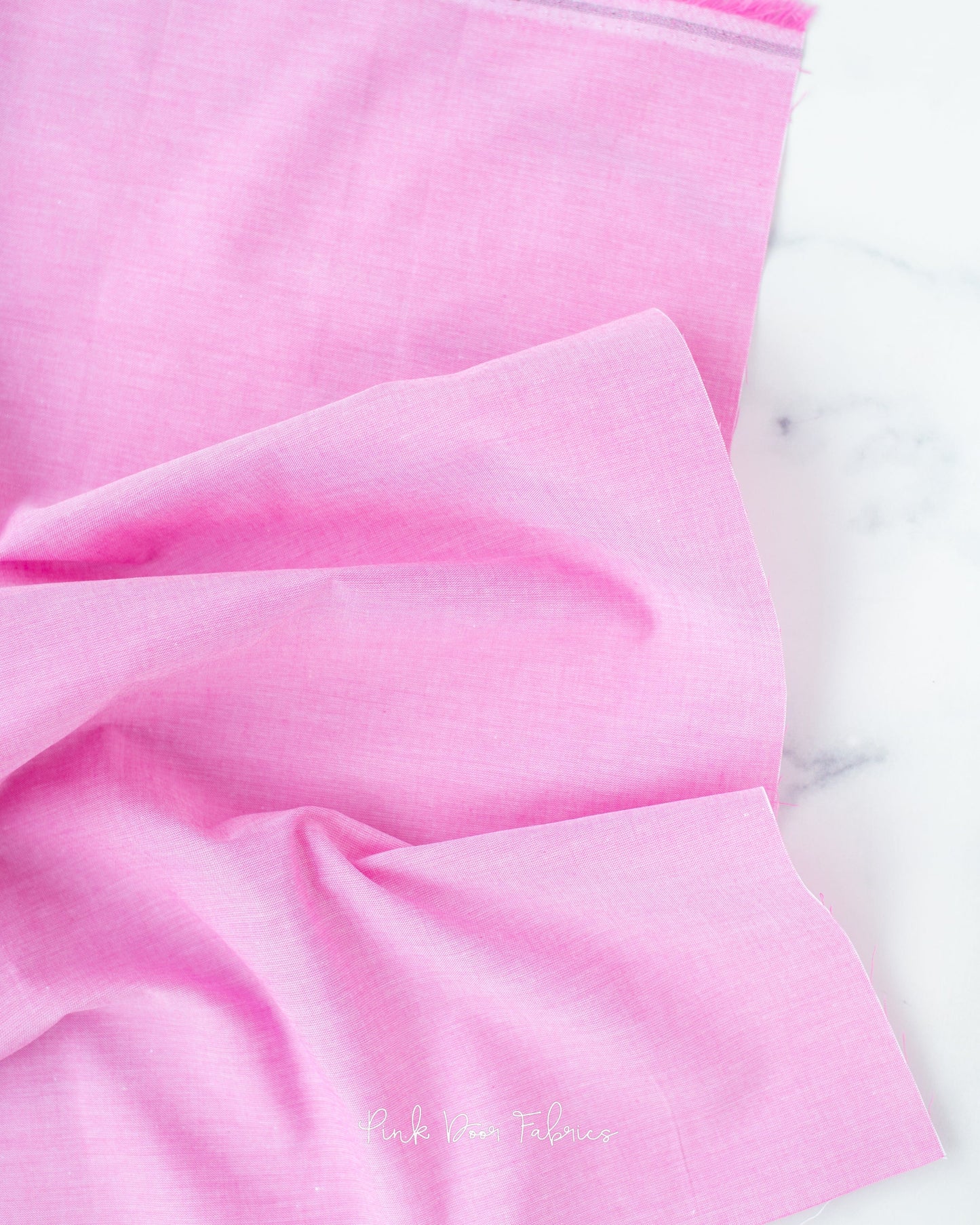 Chambray quilting fabric pattern called 'Cerise'. Part of the 'Chambray Solids' fabric collection. Designed by Tilda Fabrics for the Tilda Fabrics fabric company. SKU: 160013. 44-45 inch width.