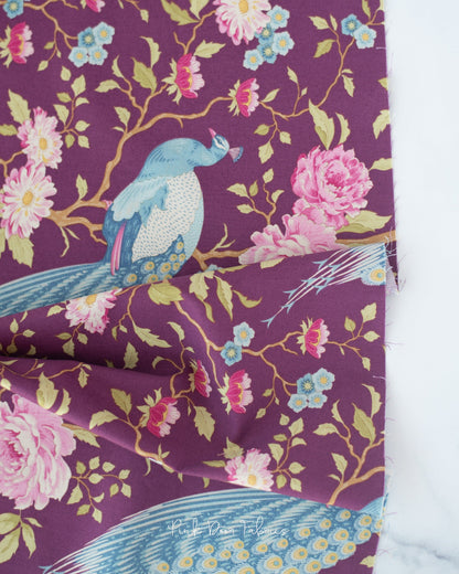 Cotton quilting fabric pattern called 'Peacock Tree in Grape'. Part of the 'Chic Escape' fabric collection. Designed by Tilda Fabrics for fabric company Tilda Fabrics. SKU: 100457. 44-45 inch width.