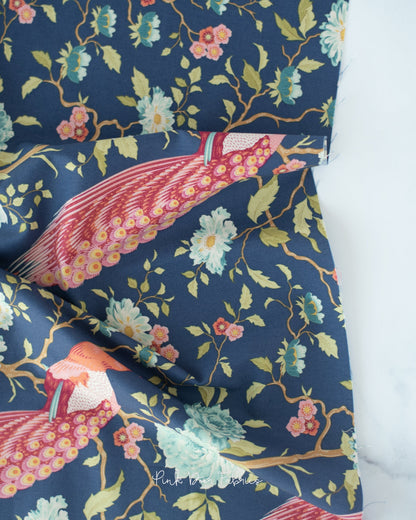 Cotton quilting fabric pattern called 'Peacock Tree in Navy Blue'. Part of the 'Chic Escape' fabric collection. Designed by Tilda Fabrics for fabric company Tilda Fabrics. SKU: 100448. 44-45 inch width.