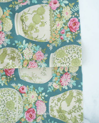 Cotton quilting fabric pattern called 'Flowervase in Petrol'. Part of the 'Chic Escape' fabric collection. Designed by Tilda Fabrics for fabric company Tilda Fabrics. SKU: 100443. 44-45 inch width.