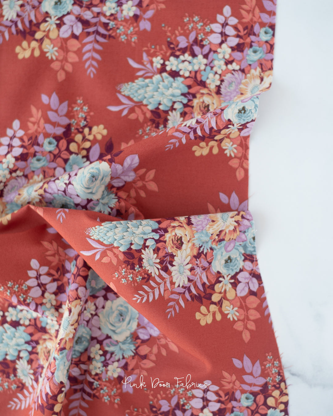 Cotton quilting fabric pattern called 'Whimsyflower in Rust'. Part of the 'Chic Escape' fabric collection. Designed by Tilda Fabrics for fabric company Tilda Fabrics. SKU: 100458. 44-45 inch width.